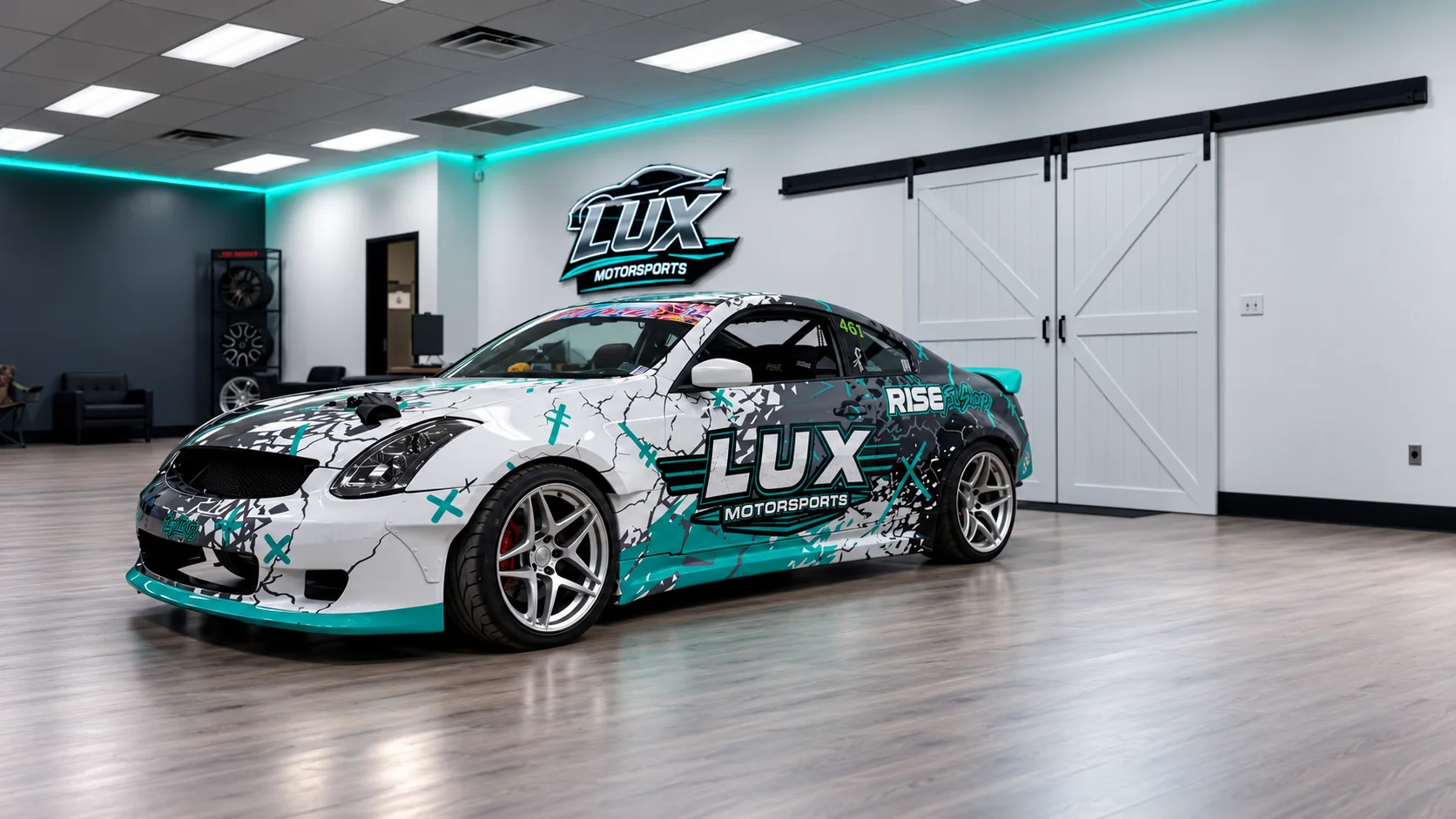 LUX Motorsports drift car inside the showroom with the LUX logo on the wall