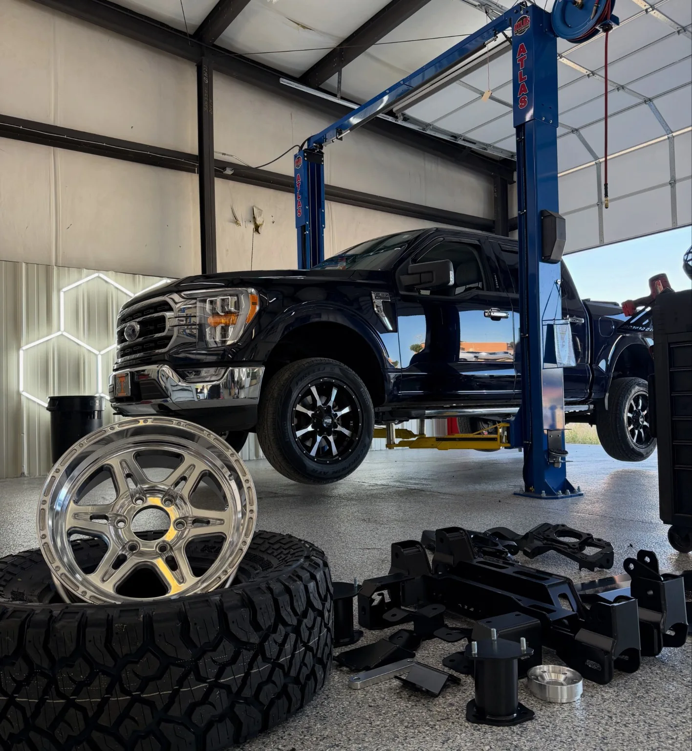 Ford truck on shop lift with wheels and tires