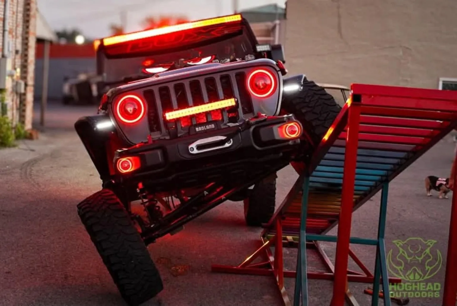Jeep displaying off-road articulation and red lighting